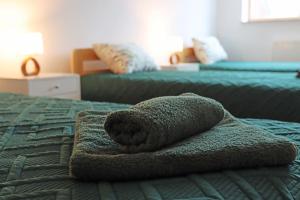 a towel animal sitting on top of a bed at Centrum Edukacji Ekologiczno-Turystycznej in Myczków