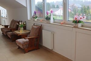 a living room with a table and chairs and windows at Centrum Edukacji Ekologiczno-Turystycznej in Myczków +48 photos