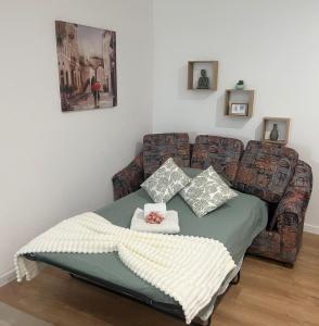 a bed with pillows and a couch in a room at Cantinho da Bia - Alojamento Local in Portel +25 photos