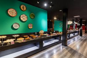 a bakery with many different types of food on display at Zarafshon Hotel Bukhara in Bukhara