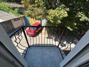 an overhead view of a balcony with a red car at Piccolo Mondo in Chişinău