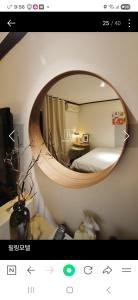 a bedroom with a round mirror on the wall at 필링모텔 스테이 