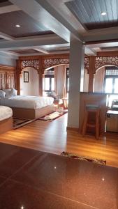 a large bedroom with two beds and a table at Boudha Stupa View Guest House in Kathmandu +100 photos