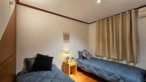 a living room with two beds and a couch at 필링모텔 스테이 