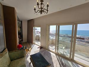 a living room with a view of the ocean at Sea Apartment -Families Only in Alexandria