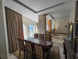 a dining room with a table and chairs and a bathroom at Sea Apartment -Families Only in Alexandria