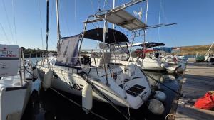 a white boat is docked at a dock at Hope Boat 42 Limanu in Limanu