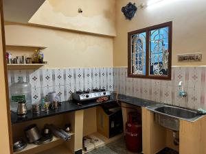 a kitchen with a sink and a counter top at Thillai Natarajar Nivas - Family Stay in Chidambaram