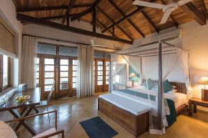 a bedroom with a bed and a desk in a room at Kottukal Beach House by Jetwing in Arugam Bay