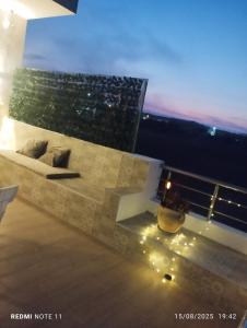 a balcony with a bed and a view of the ocean at Kelibia ezzahra 2min a pied du plage in Ḩammām al Ghazzāz
