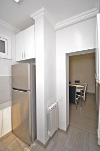 a kitchen with a refrigerator and a table at apartment in a small center near a park in Yerevan