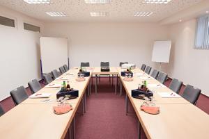 a large conference room with long tables and chairs at BSW Ferienhotel Lindenbach in Bad Ems