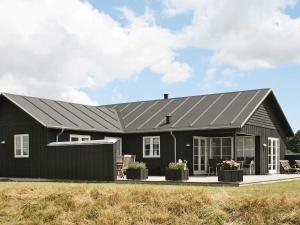 a black house with a gray roof at 10 person holiday home in Nysted-By Traum in Nysted