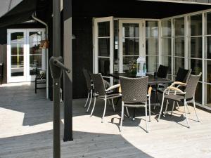 a patio with a table and chairs on a patio at 10 person holiday home in Nysted-By Traum in Nysted