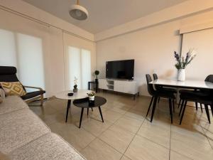 a living room with a couch and a table at Lux Apartments St Lazarus in Larnaka