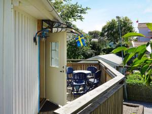 a porch with a table and chairs on a balcony at Tranquil Island Retreat in Foto-By Traum in Fotö