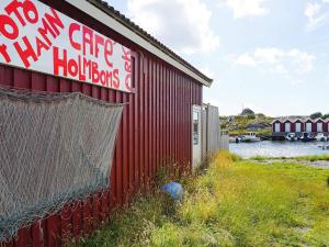 a red building with a sign on the side of it at Tranquil Island Retreat in Foto-By Traum in Fotö +30 photos