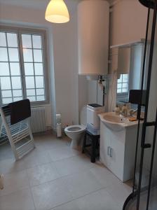 a bathroom with a toilet and a sink at O'Couvent - Appartement 242 - 1 chambre - 72m2 - Quatrième étage in Salins-les-Bains