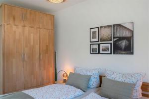a bedroom with a bed and a large wooden cabinet at Weitblick - in 5 min am Meer in Wangerland