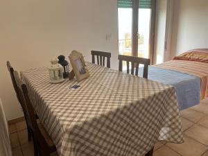a table with a checkered table cloth with a picture on it at La Vista in Otricoli