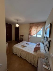a bedroom with a large bed with a window at La casita de carmen in Cazorla +11 photos