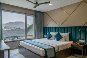 a bedroom with a bed and a large window at Hotel Highway King Shahpura in Shāhpura +72 photos