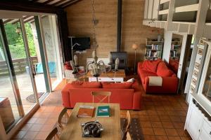 a living room with a red couch and a table at Bungalow with View near Coo in Stavelot