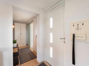a hallway with white walls and a door at Garden Comfort in Rieder, Harz in Ballenstedt +34 photos