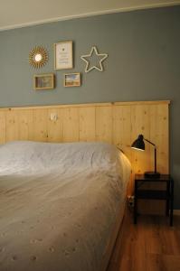 a bedroom with a bed and a star on the wall at Chalet Aan de rand - Veluwe in Putten +21 photos