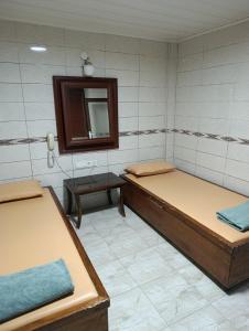 a room with two beds and a mirror at uç su havuzlu termal in Kızılcahamam