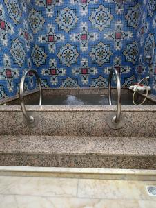 a set of stairs with metal handles in a bathroom at uç su havuzlu termal in Kızılcahamam
