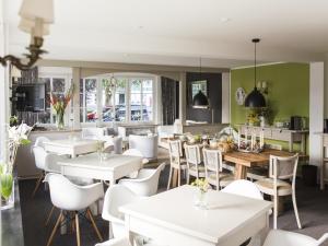 a restaurant with white tables and white chairs at Ferienhaus mit Sauna in Winterberg in Winterberg
