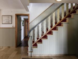 a staircase in a house with white walls and wood floors at Winterberg Gruppenhaus mit Sauna ideal für Familien & Freunde in Winterberg