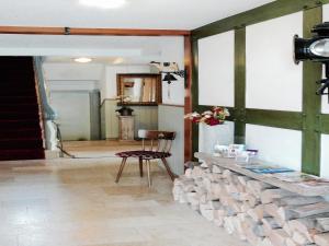a living room with a table and a chair at Ferienhaus mit Sauna in Winterberg in Winterberg