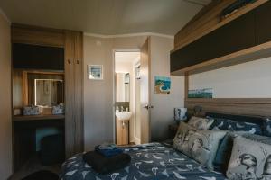 a bedroom with a bed with a blue comforter at Serenity in Saint Erth