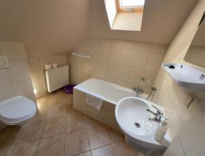 a white bathroom with a sink and a toilet at Babie Lato in Włodarka +55 photos