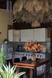 a kitchen with a table with a bunch of oranges on it at North House in Tây Ninh