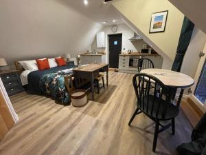 a bedroom with a bed and a desk and a table at Roseberry View Barn, Northallerton in Northallerton