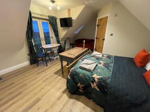 a bedroom with a bed and a table in a room at Roseberry View Barn, Northallerton in Northallerton