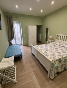 a bedroom with a large bed in a room at Don Mimì Casa Vacanza in Torre del Greco