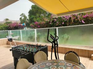a stove in a room with a table and chairs at Agadir Best Apparts in Agadir nʼ Aït Sa