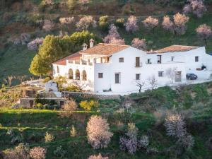 an aerial view of a large white house on a hill at Cortijo J&S Juan Salvador in Málaga