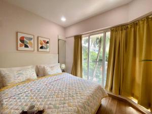a bedroom with a bed and a large window at Modern 2bed Bandra AreaParkingUnit 2 in Mumbai