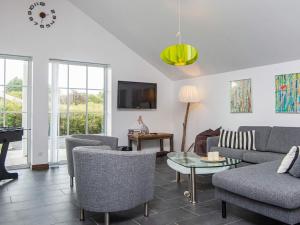 a living room with a couch and a table at 5 star holiday home in Ansager in Ansager