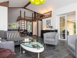 a living room with a couch and chairs and a table at 5 star holiday home in Ansager in Ansager +32 photos