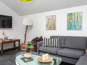 a living room with a couch and a table at 5 star holiday home in Ansager in Ansager
