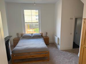 a bedroom with a bed and a window at 3 Russell street, Flat 2 in Gloucestershire