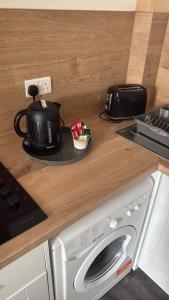 a kitchen counter with a microwave and a washing machine at 3 Russell street, Flat 2 in Gloucestershire