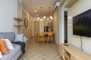 a living room with a couch and a table at The Family Den Upton By Elica in Kuching