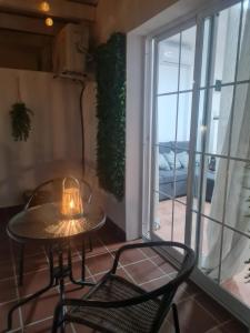 a table and chairs in a room with a window at Coco Stay Nerja in Nerja +6 photos